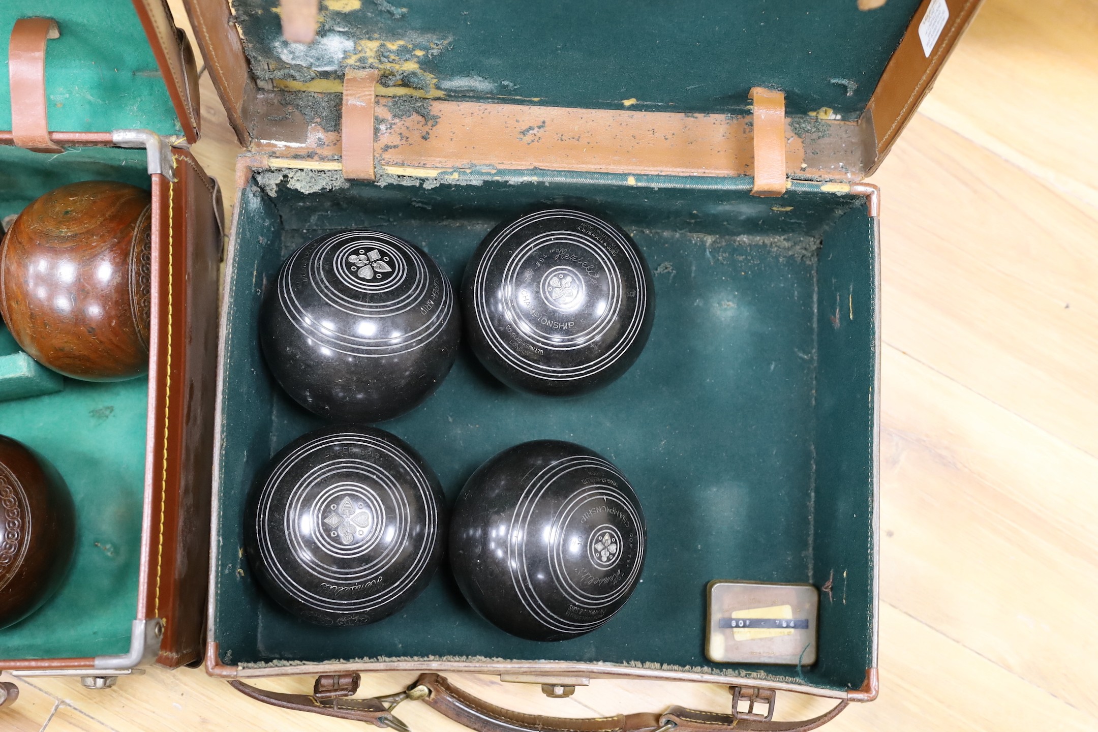 A set of four Slazengers bowls balls and another set of four Douglas Kenn ltd. ‘Henselite’ bowls balls, both in leather cases